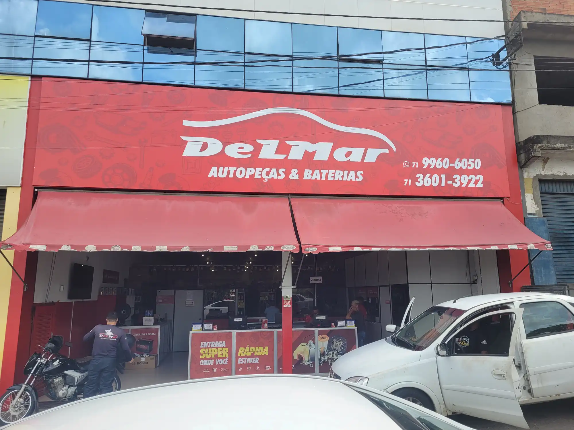 Fachada vermelha de uma loja DELMAR Autopeças & Baterias